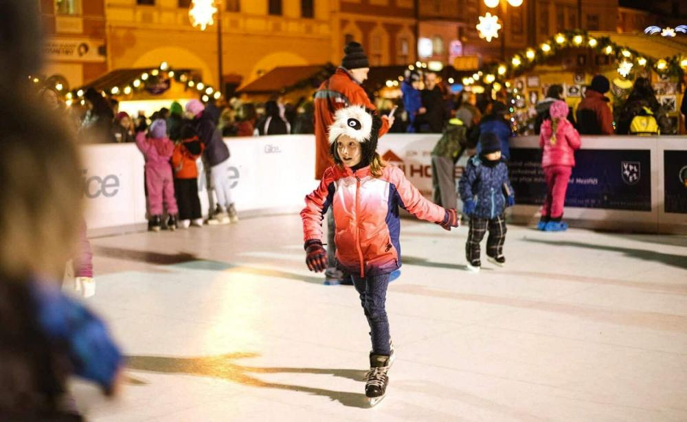 girl skating on artificial christmas rink